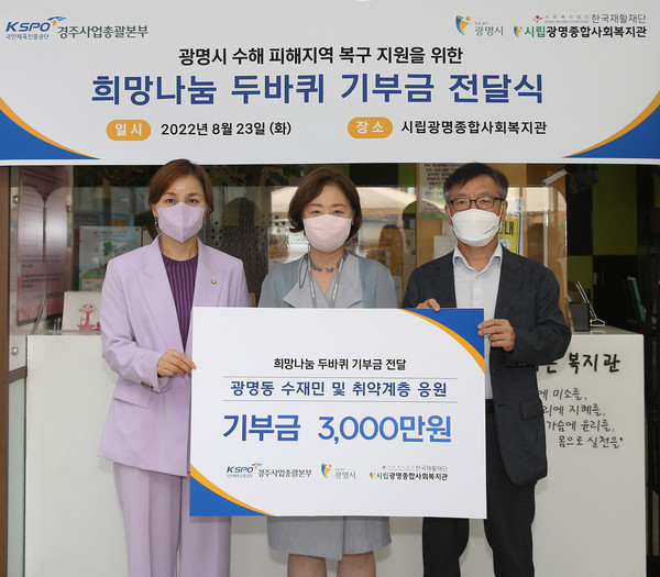 이맹규 경주사업총괄본부 경륜경정건전화본부장(오른쪽)이 신혜정 광명종합사회복지관장에게 기부금을 전달하고 임오경 국회의원(왼쪽)과 기념 촬영을 하고 있다. 사진=국민체육진흥공단 경주사업총괄본부 제공