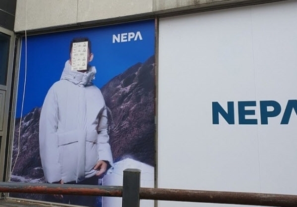 아웃도어 브랜드 네파 광고판에 배우 유아인의 얼굴이 종이로 가려져있다. 사진=온라인 커뮤니티 캡처