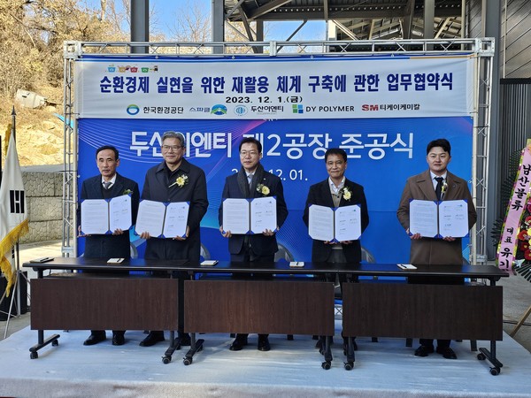 최창배 DY폴리머 대표(왼쪽에서 네번째)와 행사에 참석한 관계자들이 협약서를 들고 기념촬영을 하고 있다. 사진=SK에코플랜트 제공