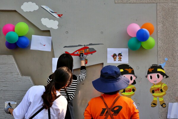 지난 20일 서울 광진구 능동 광나루안전체험관에서 티웨이항공 임직원과 소방관들이 안전의식을 제고하는 '벽화그리기 봉사활동'을 진행하고 있다. 사진=티웨이항공